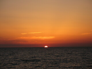 Alanya, TURKEY - August 10, 2013: Travel to Turkey. Beaches on the Mediterranean coast. The sun is leaving the horizon. Sunset