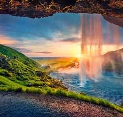  Great sunset on popular tourist destination - Seljalandsfoss waterfall, where tourists can walk behind the falling waters. Impressive summer scene of Iceland. Beauty of nature concept background. © Andrew Mayovskyy