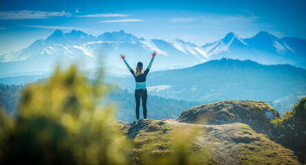 Slovakia mountain landscape. Nature fields. High Tatras, Europe, Belianske Tatry. Happy woman on the sunset in nature in summer with open hands