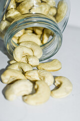 Cashew nuts in a glass bottle with white background .A food that is beneficial to health Eaten as a snack is tasty