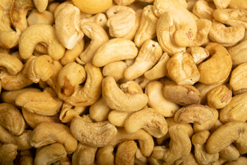 Cashew nuts scattered surface texture. Close up.