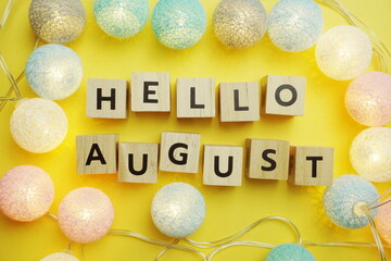 Hello August alphabet letter with LED Cotton ball Decoration on yellow background