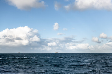 The Atlantic ocean in Bretagne France with a cloudy friendly sky and no boat.