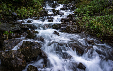 Naklejka premium A waterfall amid foliage in Langtang National Park in Nepal. Freshwater source.