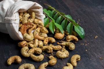 cashew nuts on a wooden background with coriander