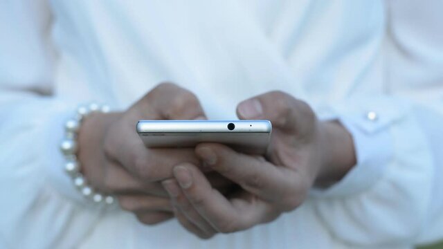 Close up of a woman's hand holing and using a mobile phone hd stock footage