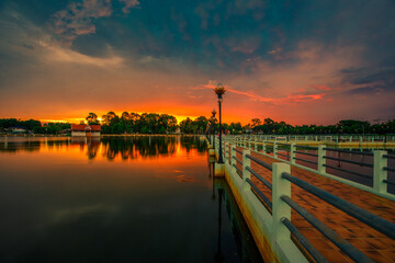 The blurry abstract background of the morning sky by the reservoir and there is a walkway to watch nature for exercise or rest while traveling.