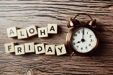 Aloha Friday alphabet letter with alarm clock on wooden background