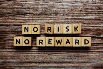 No Risk NO Reward alphabet letter on wooden background