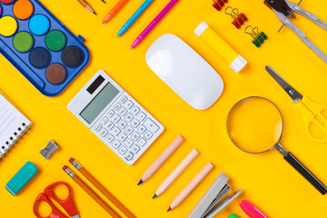 School supplies flat lay on yellow background