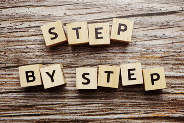 Fototapeta premium Step By Step alphabet letter on wooden background