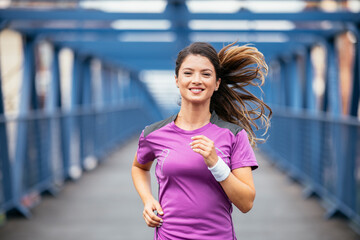Young female athlete jogging outdoors