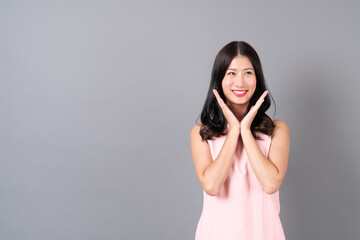 Young asian woman happy smiling in pink dress