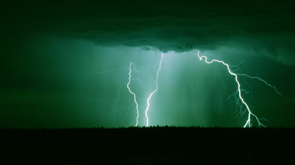 several lightning strikes during a strong thunderstorm over the lake