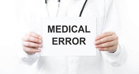 Doctor holding a card with text Medical error, medical concept