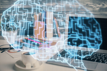 Double exposure of desktop computer and human brain drawing hologram. Ai concept.