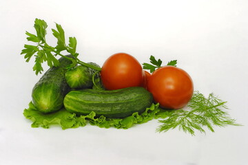Cucumbers and tomatoes on white isolated background