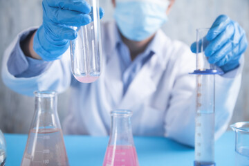 Girl working with flask in a laboratory.