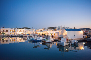 Traditional greek fishing village in Paros island, Greece. Beautiful sunset view of Naoussa,...