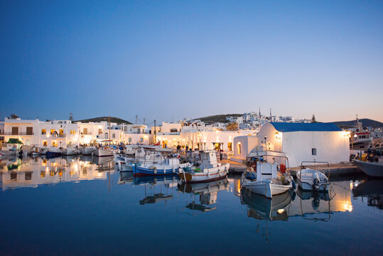 Traditional greek fishing village in Paros island, Greece. Beautiful sunset view of Naoussa, Cyclades. Popular tourist destination in Europe