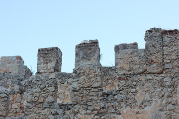 Alanya, TURKEY - August 10, 2013: Travel to Turkey. Clear blue sky. Alanya city. An ancient fortress. Destroyed brick walls.