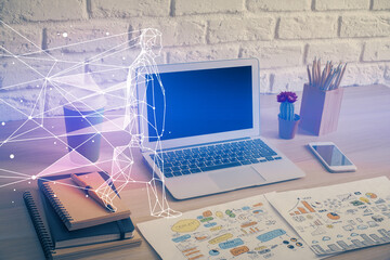 Desktop computer background in office and start up theme hologram drawing. Double exposure. Startup concept.