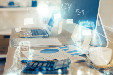 Desktop computer background in office and flying envelops hologram drawing. Multi exposure. Electronic mail concept.