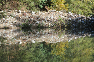 Alanya, TURKEY - August 10, 2013: Travel to Turkey. Reflection in the purest water. Mountain river. Green forest, hills and mountains.