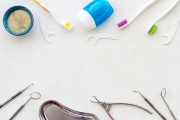 Pattern of dentist equipment. Tools, toothbrushes, dental floss flat lay, top view