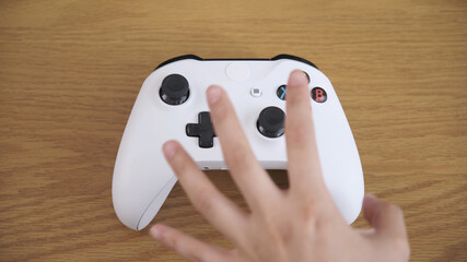 ゲームコントローラーを掴む手  © aijiro