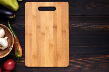 Multifunctional wooden cutting board for bread or steak serve. Top view on wooden kitchen table. Copy space 