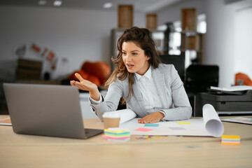 Beautiful young businesswoman working on projects. Businesswoman in suit working in the office.	