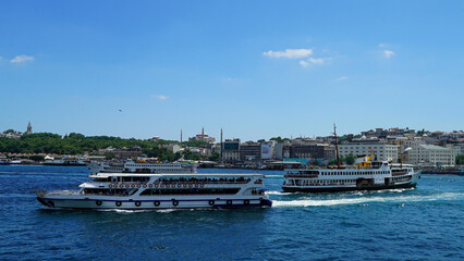 Fototapeta na wymiar Golden Horn against mosques, Istanbul, Turkey. Panorama of Istanbul waterfront in summer. Beautiful view of an old part of Istanbul city. Vacation and traveling in Istanbul.