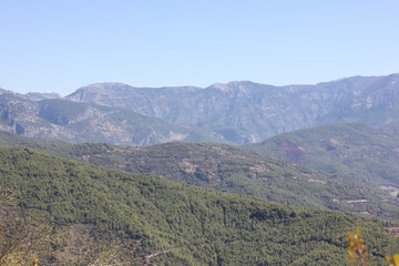 Alanya, TURKEY - August 10, 2013: Travel to Turkey. Helene Hills. Mountains in the background in the distance. Rocks, wildlife of Turkey. Forest and clear blue sky.