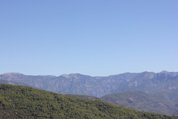 Alanya, TURKEY - August 10, 2013: Travel to Turkey. Helene Hills. Mountains in the background in the distance. Rocks, wildlife of Turkey. Forest and clear blue sky.