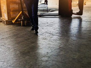 Obraz premium Worker driving forklift loading and unloading shipment carton boxes and goods on wooden pallet from container truck to warehouse cargo storage in logistics and transportation industrial 