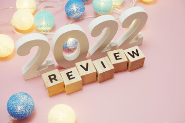 Review 2022 word alphabet letters on pink background