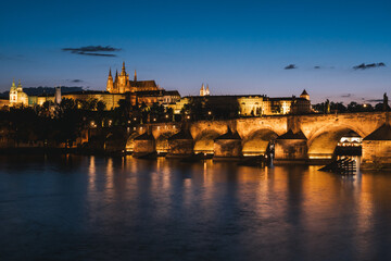 Charles Bridge in Prague at Night across River Vltava with Saint Vitus Cathedral and Prague Castle Cityscape