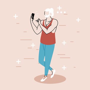 a young man takes a selfie and holds his smartphone in his hand