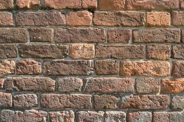 Background and texture old shabby red brick stone wall.