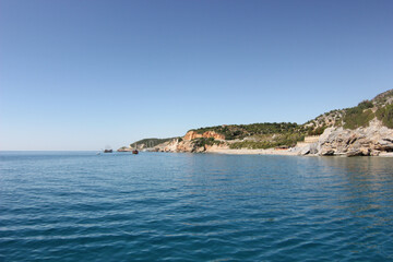 Alanya, TURKEY - August 10, 2013: Travel to Turkey. The waves of the Mediterranean Sea. Water surface. Mountains and hills on the coast of Turkey. Green hills.
