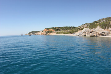 Alanya, TURKEY - August 10, 2013: Travel to Turkey. The waves of the Mediterranean Sea. Water surface. Mountains and hills on the coast of Turkey. Green hills.