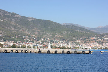 Fototapeta premium Alanya, TURKEY - August 10, 2013: Travel to Turkey. The waves of the Mediterranean Sea. Water surface. Mountains and hills on the coast of Turkey. Green hills.
