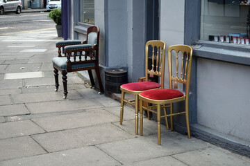 Fototapeta na wymiar Empty Chairs on Deserted Pavement outside Shop 