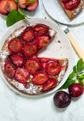 Plum Tarte Tatin , a traditional flat cake with fresh plums