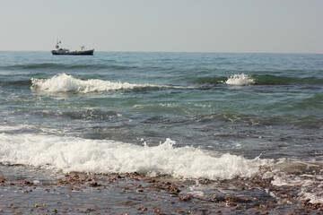 Alanya, TURKEY - August 10, 2013: Travel to Turkey. Beaches on the sea. Waves on the Mediterranean coast.
