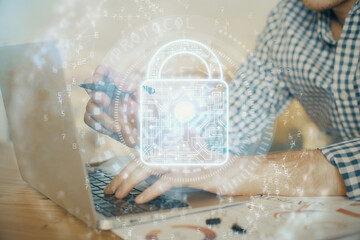 Double exposure of lock icon with man working on computer on background. Concept of network security.