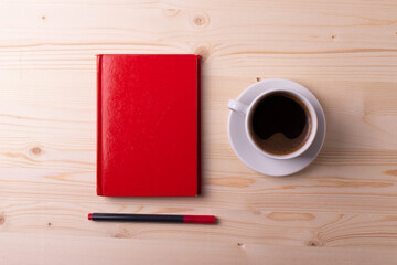 a white ceramic cup with black espresso, french croissant as breakfast or snack concept on rustic, natural texture wooden surface