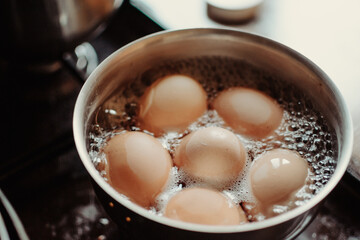 Fototapeta na wymiar Eggs are boiling with high temperature. Cooking chicken eggs in pot. Boiled eggs.