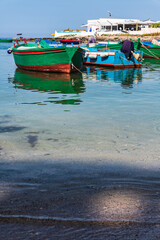 Fototapeta na wymiar Monastery and boats frame the bay of San Vito. Polignano a mare